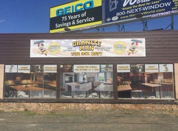 Storefront of a seafood restaurant with a yellow sign and outdoor window displays under billboard ads