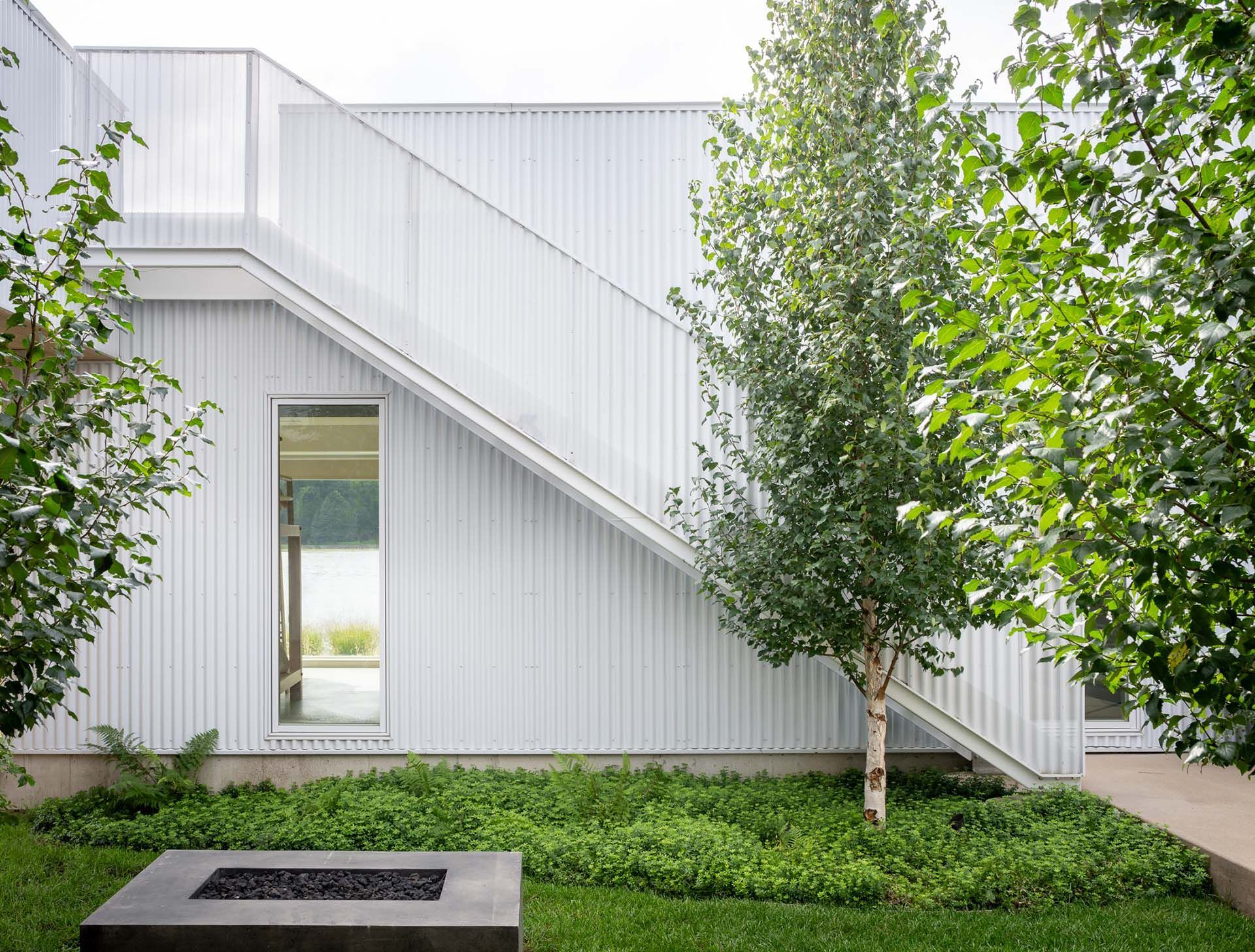 A white house with a staircase leading up to the second floor.