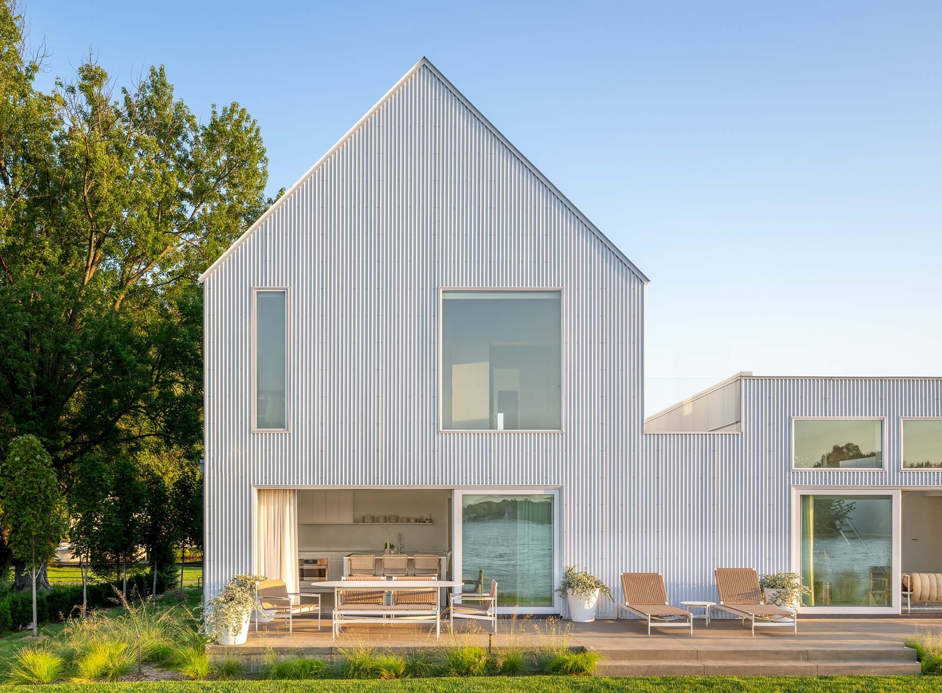 A white house with a sharply pitched roof.