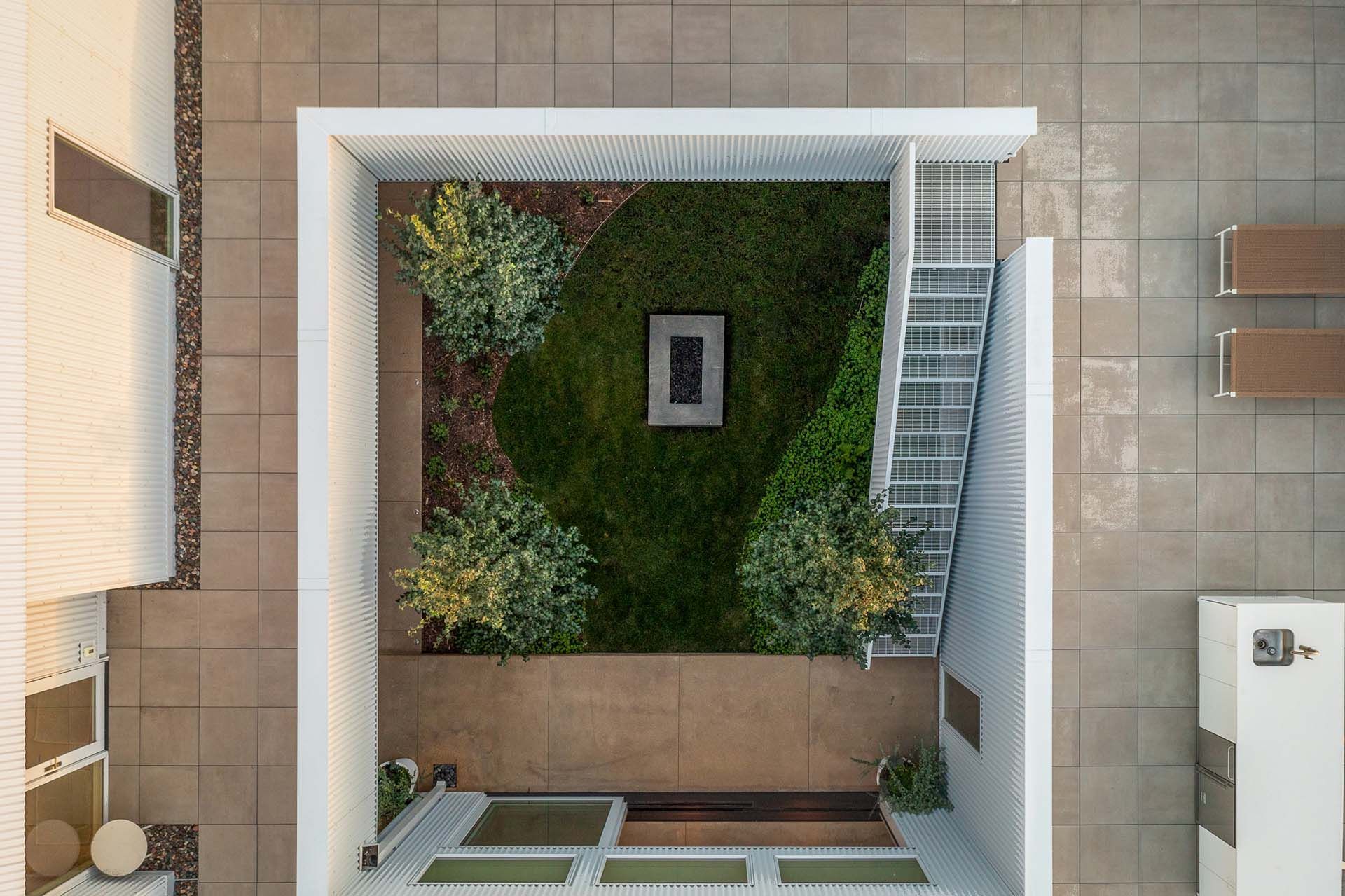 Overhead view of a custom home, showing the patio area and stairway