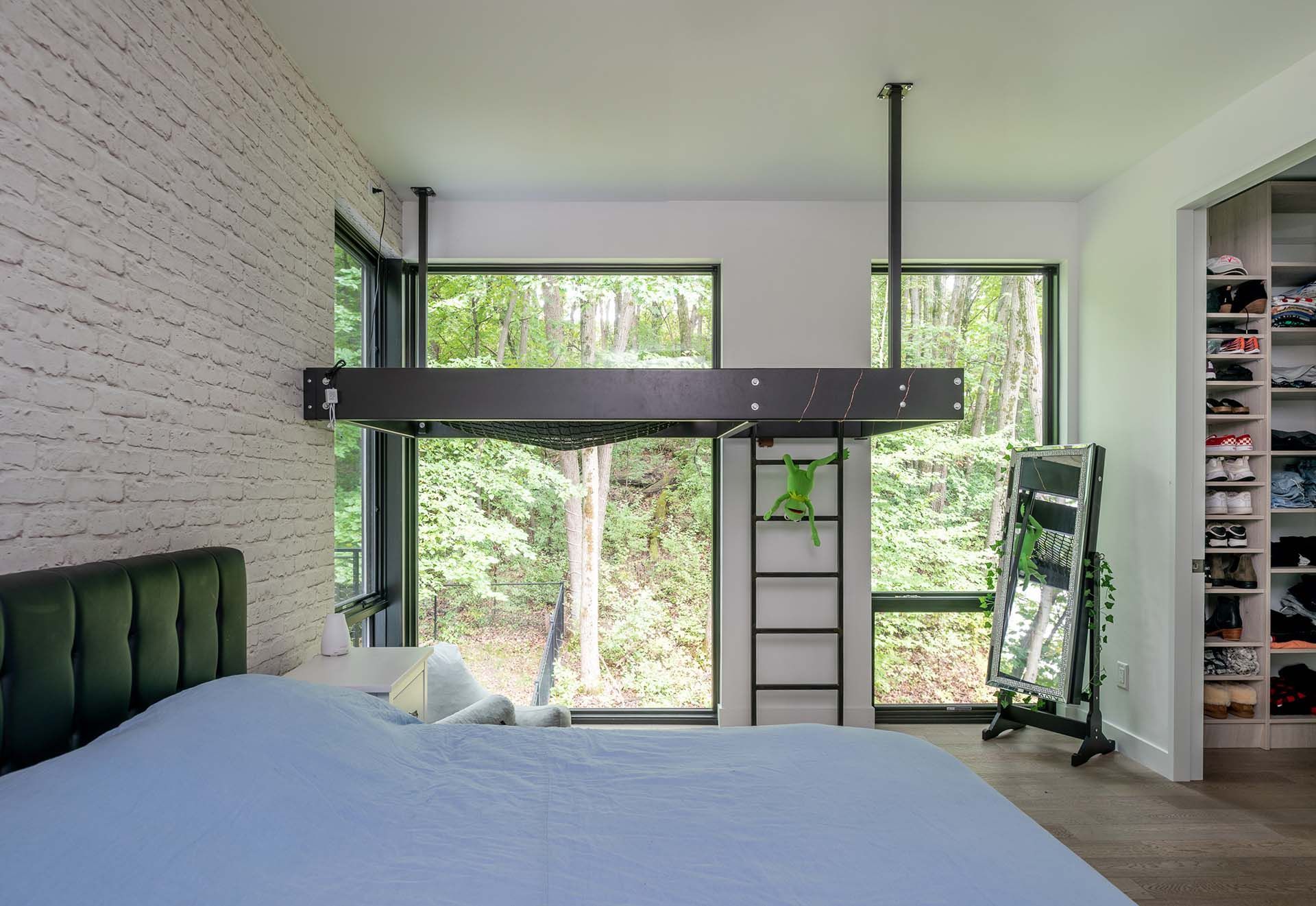A bedroom with a bunk bed and a ladder