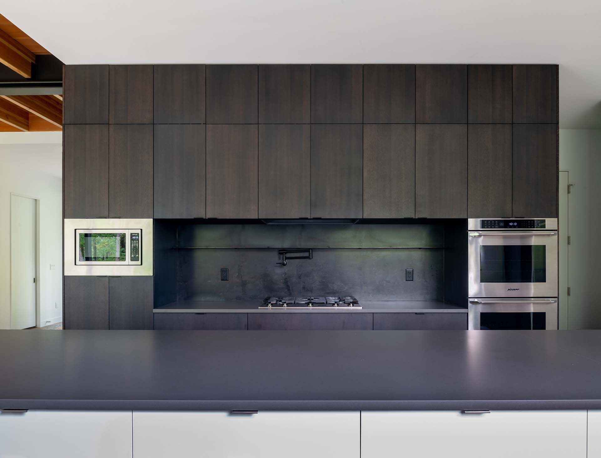 A kitchen with a stove top oven and a microwave