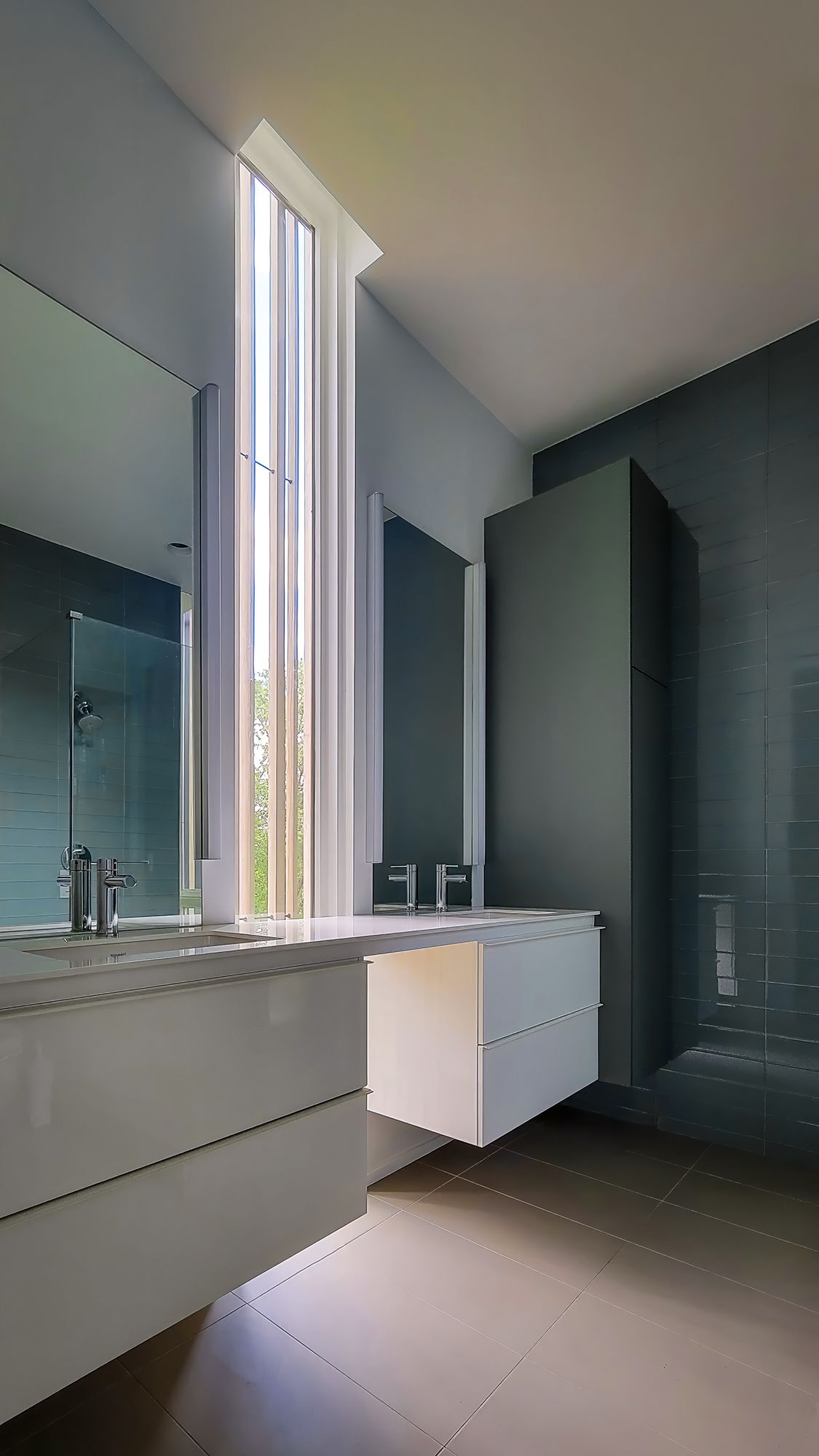 a bathroom with a sink, mirror, and shower