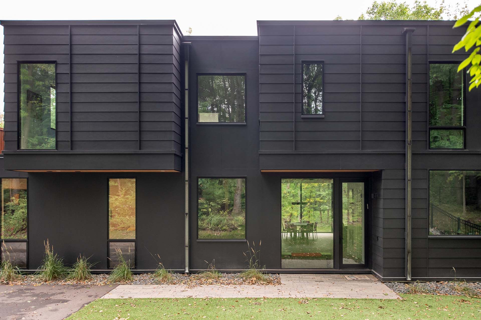 A large black house with a lot of windows