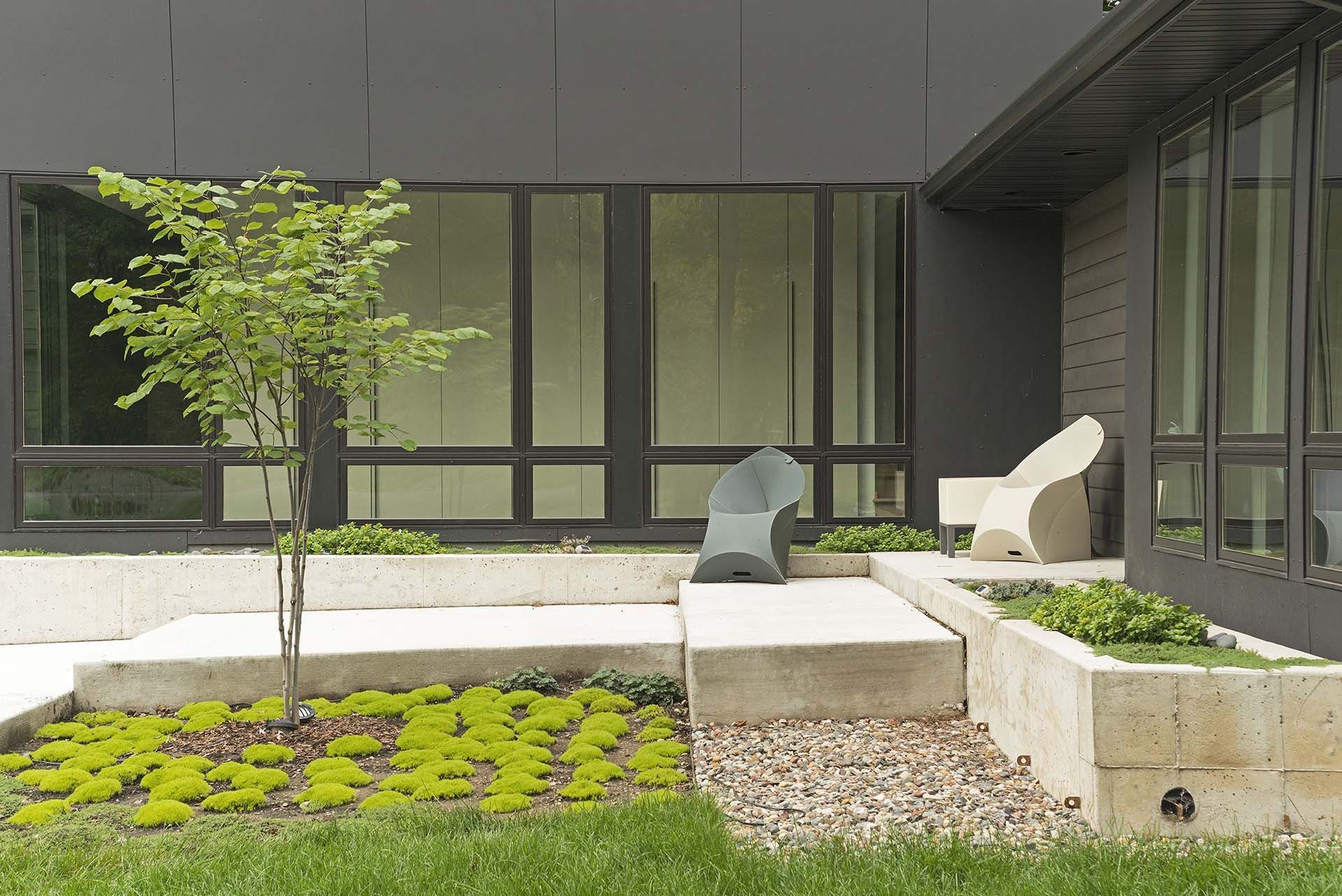 A building with a lot of windows and a garden in front of it