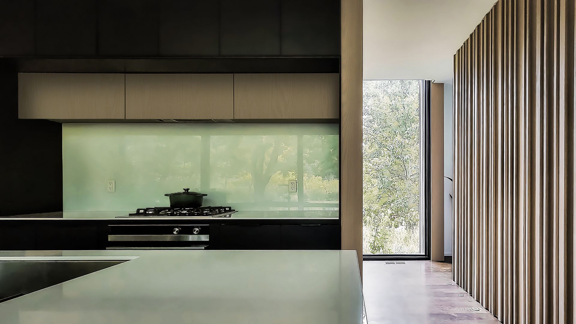 a kitchen with a pot on the stove and a large window