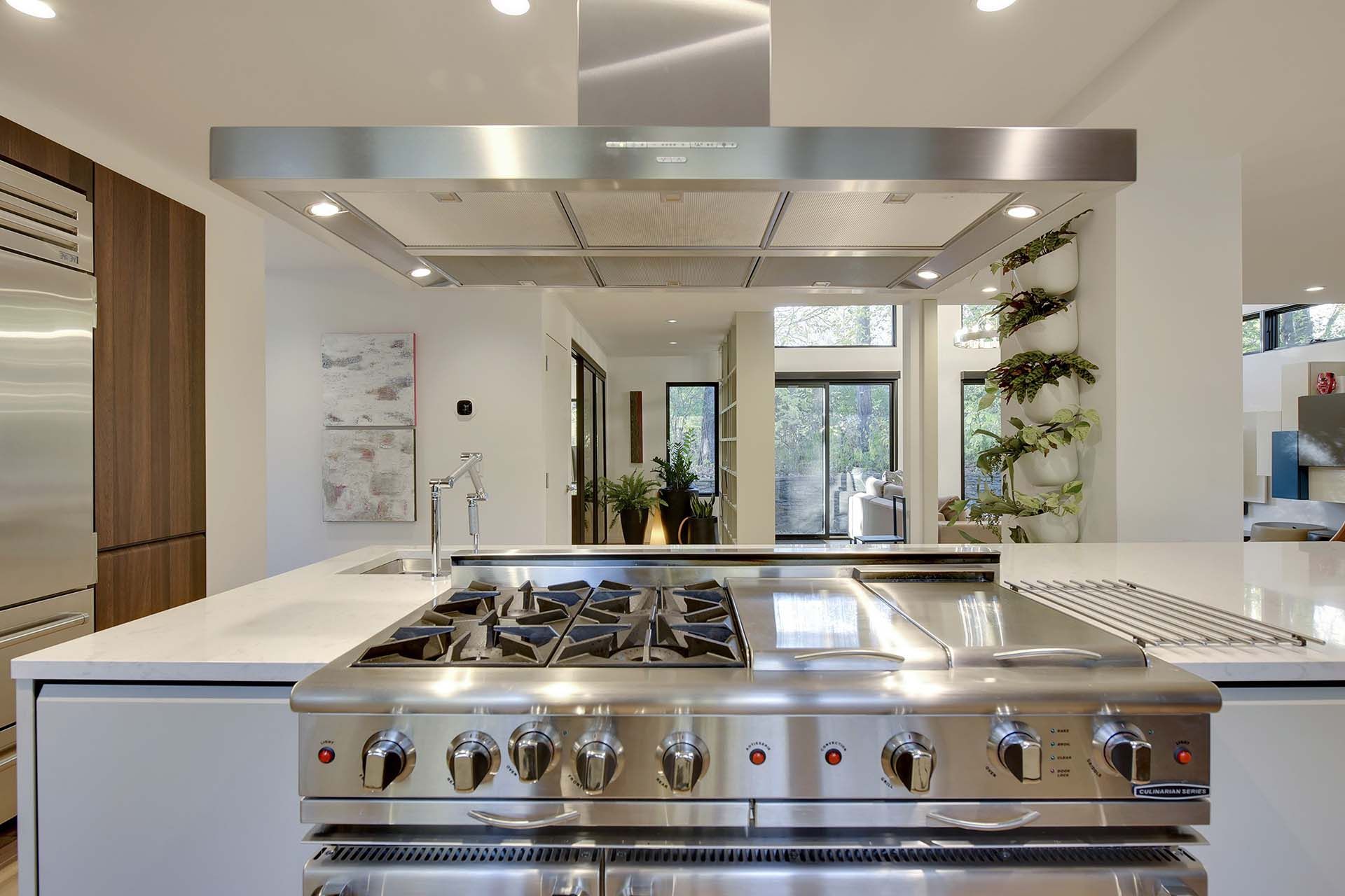 A kitchen with stainless steel appliances and a stove top oven