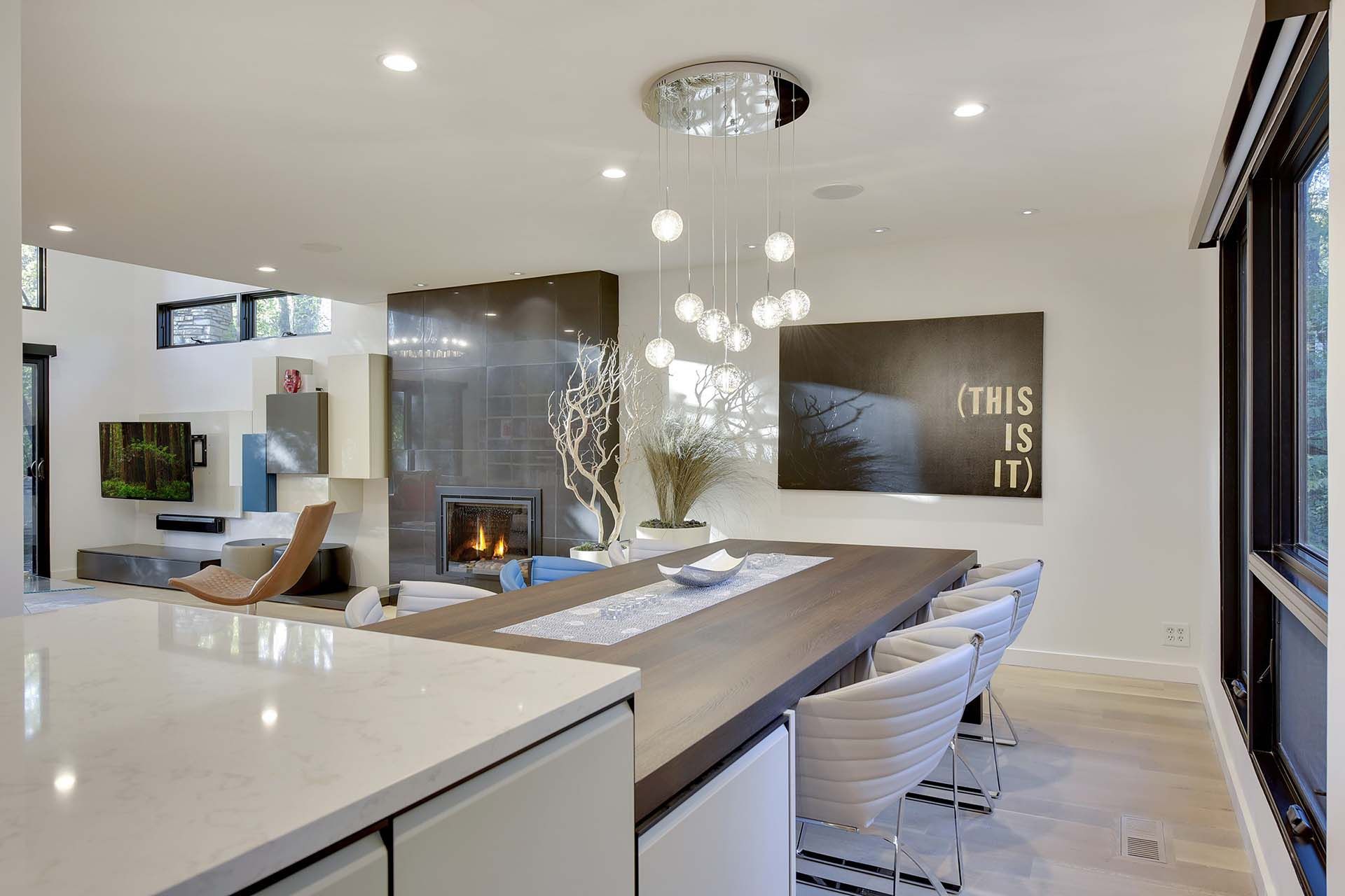 A kitchen and dining room in a house with a sign that says this is it