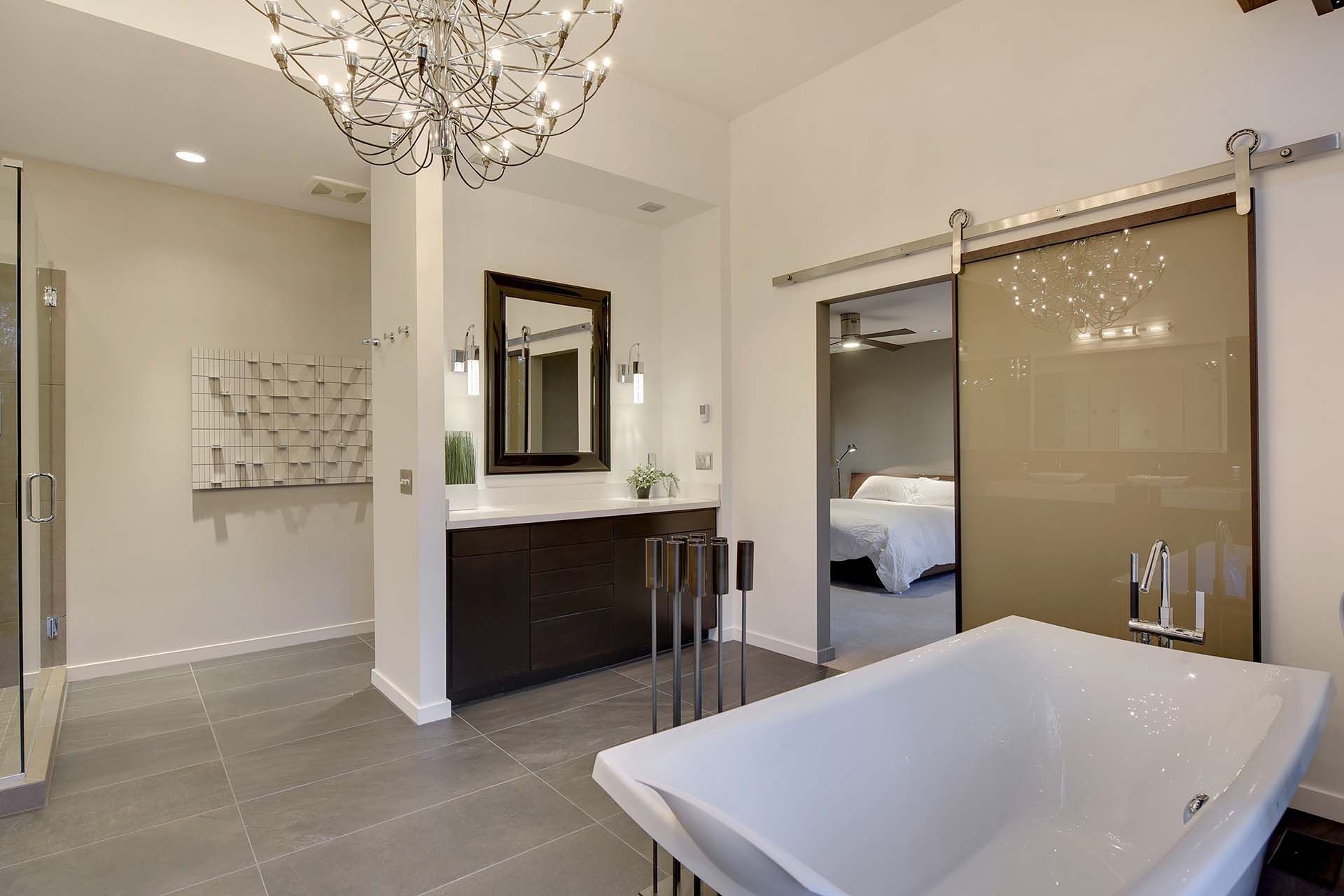 A bathroom with a bathtub and a sliding glass door
