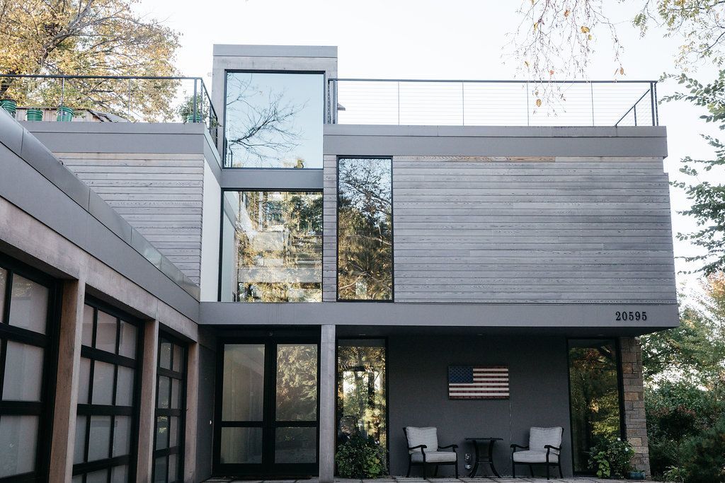A modern house with a large american flag on the side of it