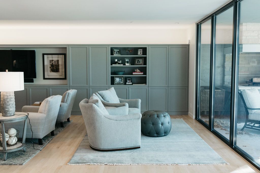 A living room with a lot of furniture and sliding glass doors