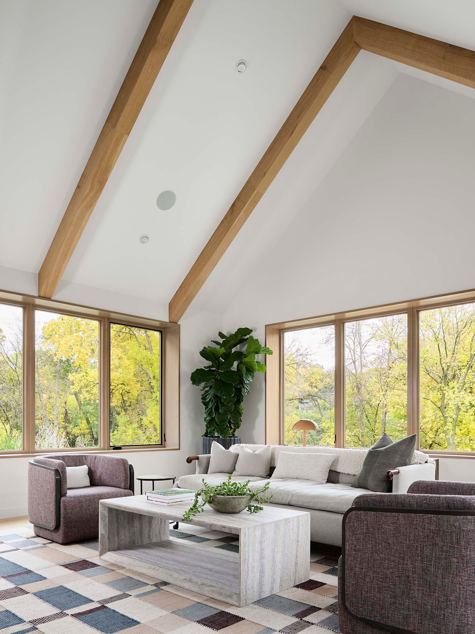A living room with a couch , chairs , and a coffee table.