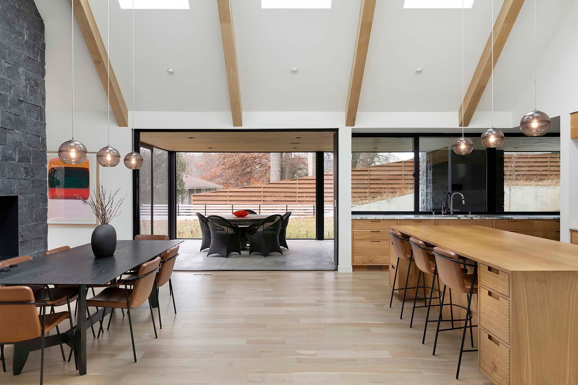 A large room with a dining table and chairs and a kitchen.