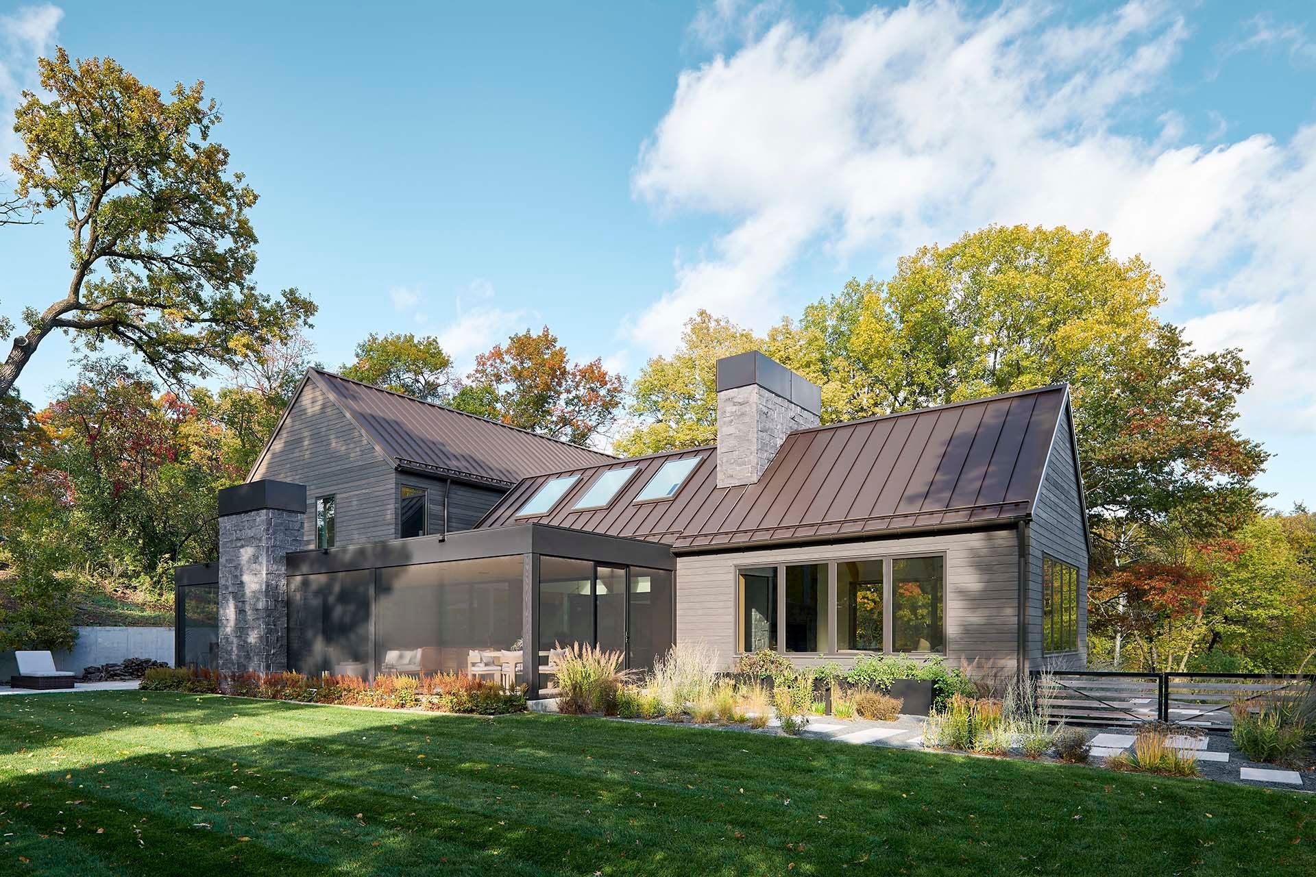 A large house with a lush green lawn in front of it.