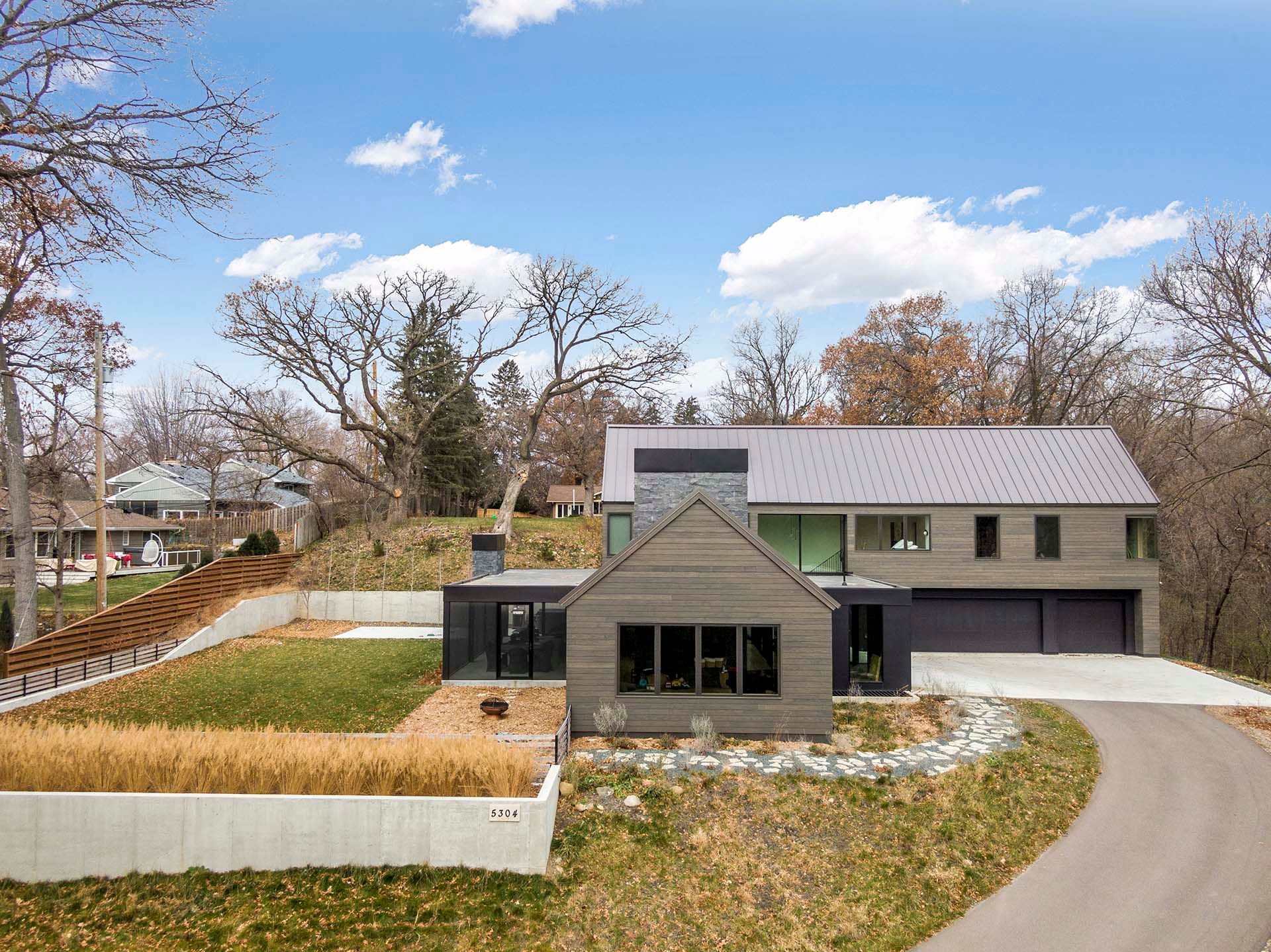An aerial view of a large house with a driveway leading to it.
