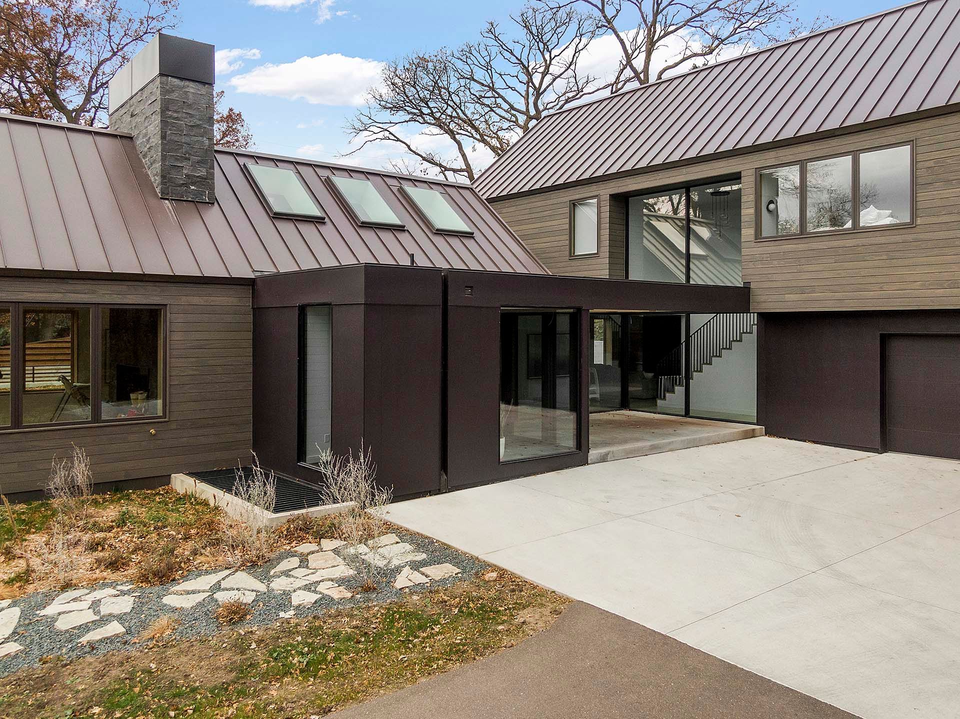 A large house with a metal roof and a lot of windows
