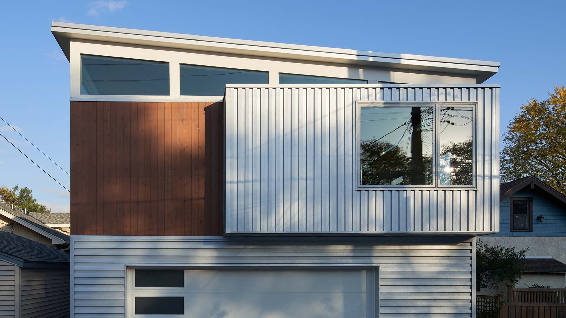 A modern house with a garage and a balcony