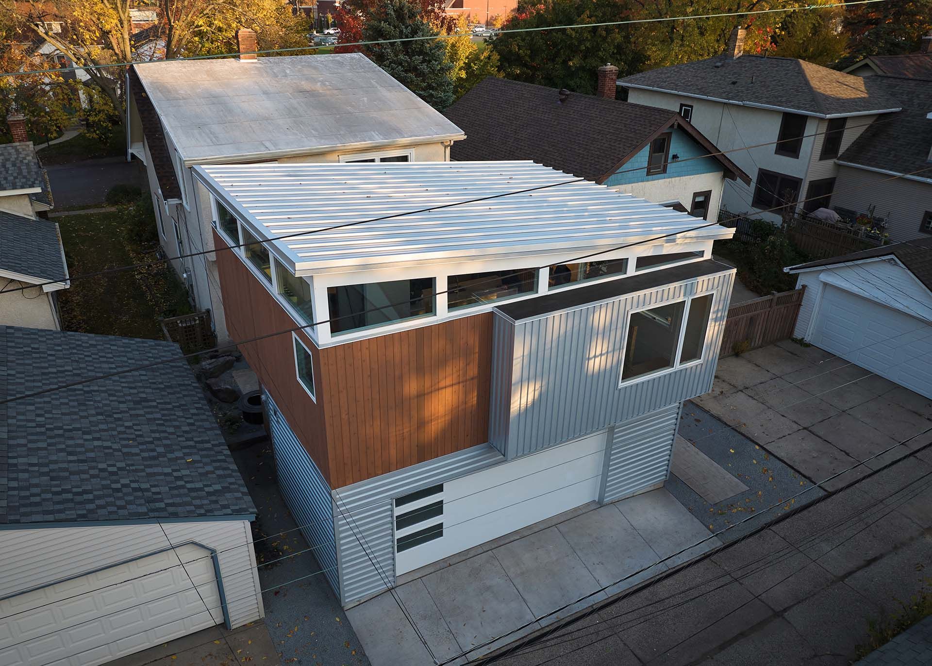 An aerial view of a house with a white roof