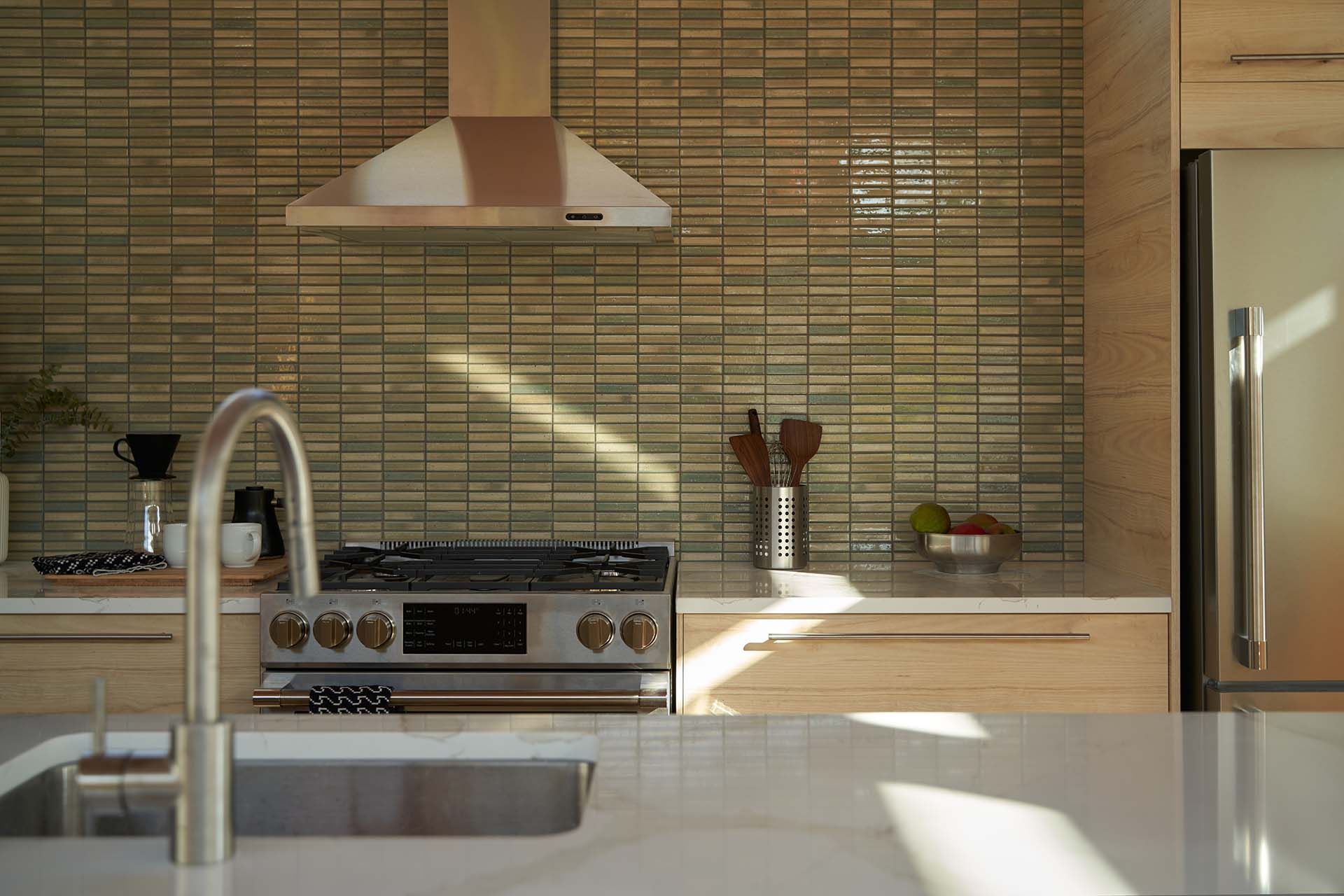 A kitchen with a stove , sink , and refrigerator.