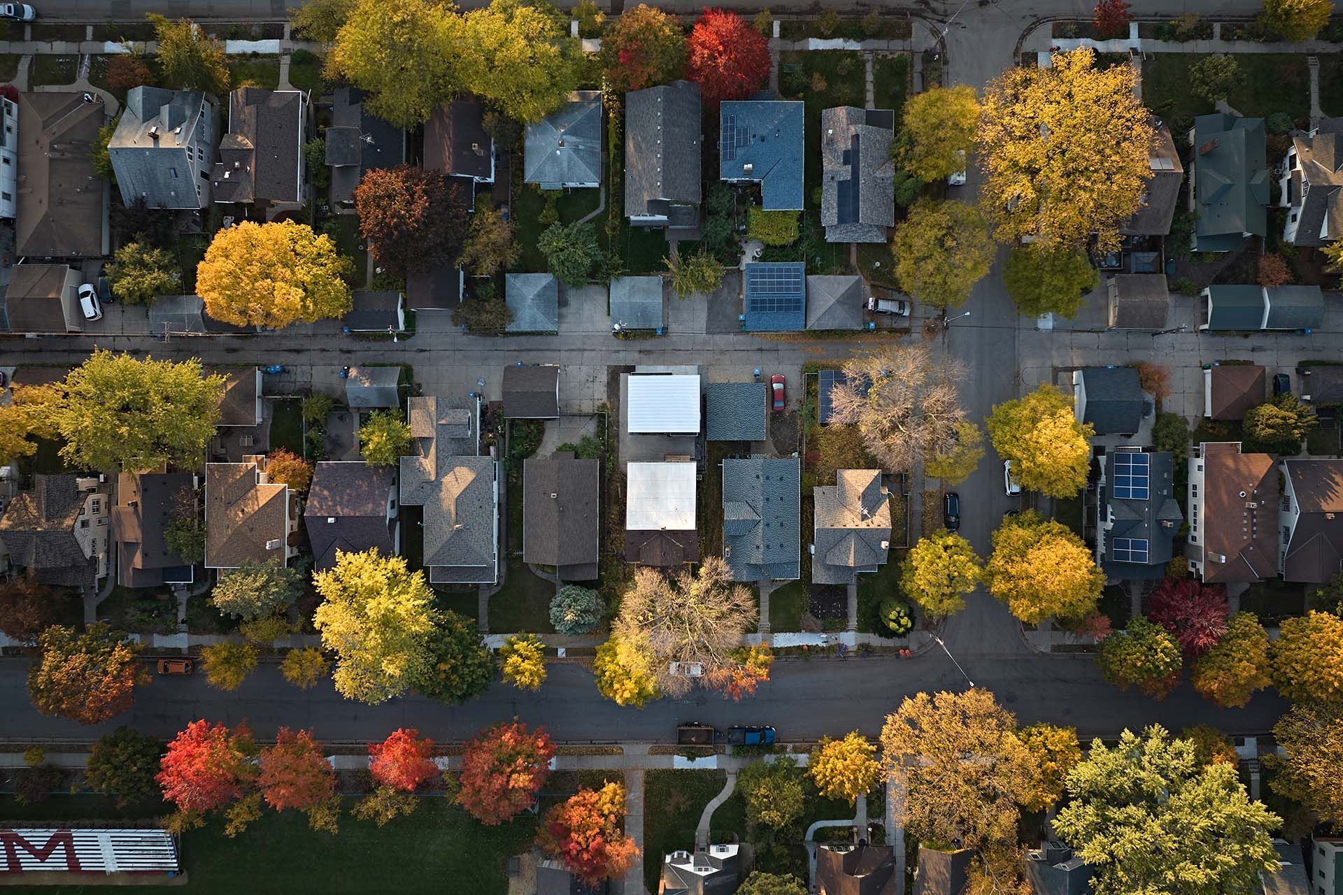 An aerial view of a residential neighborhood in autumn