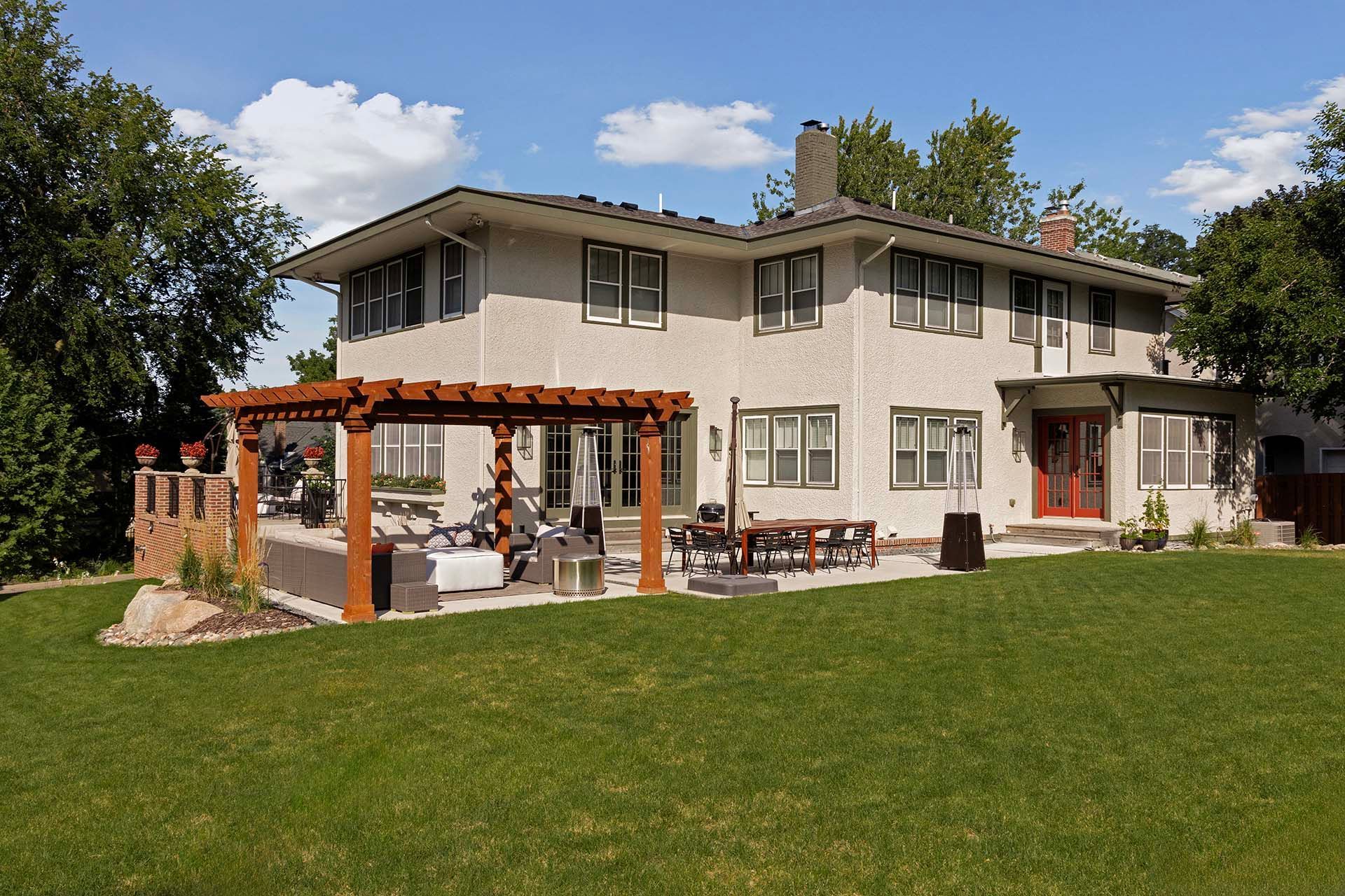 A large house with a pergola in front of it