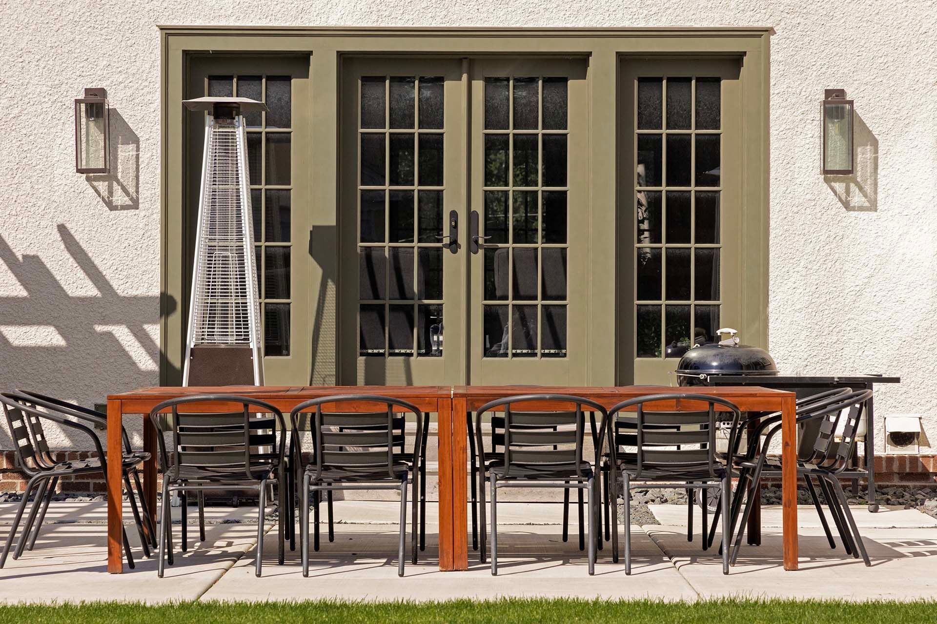 A patio with a table and chairs and a heater