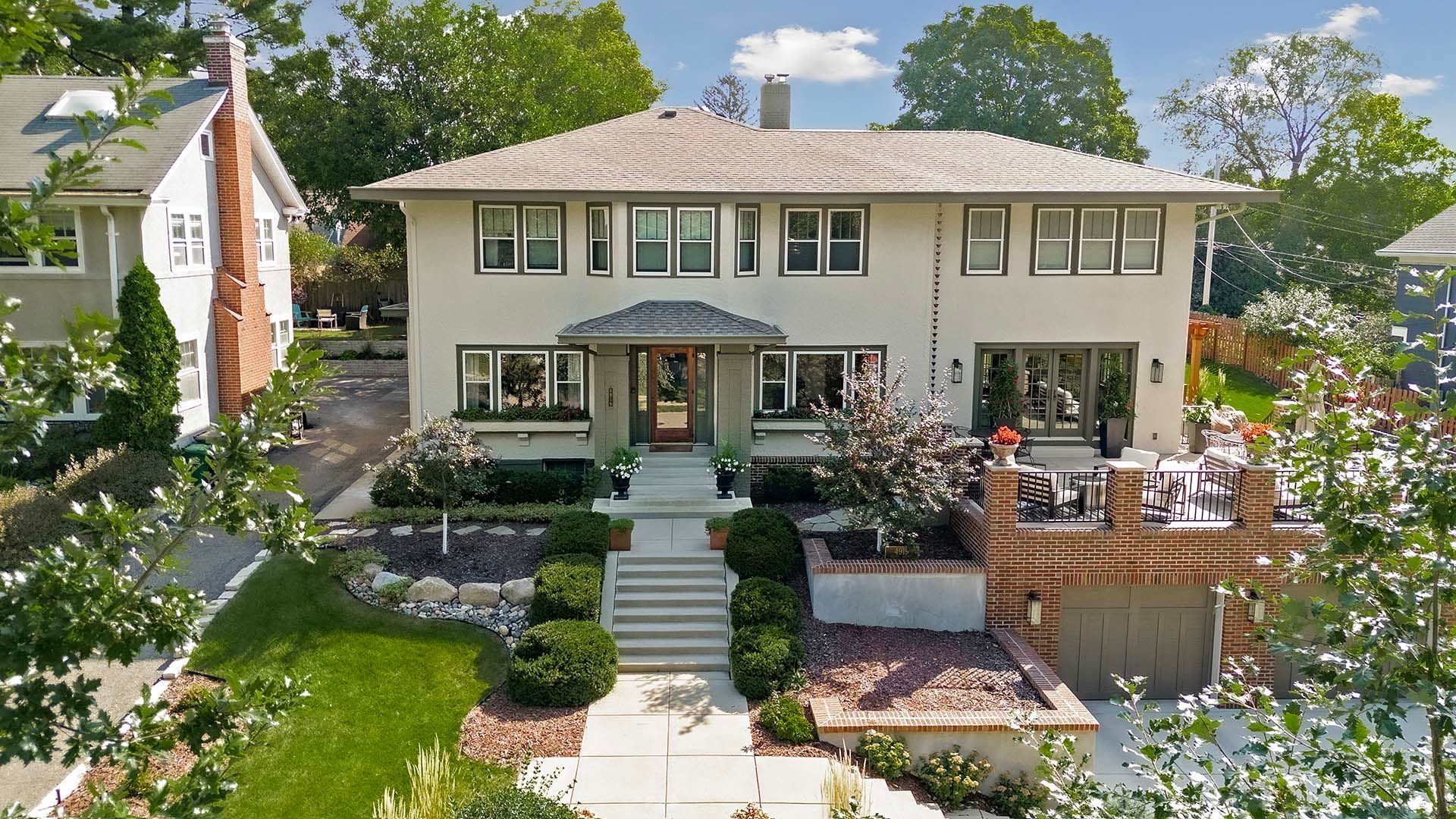 An aerial view of a large white house surrounded by trees.