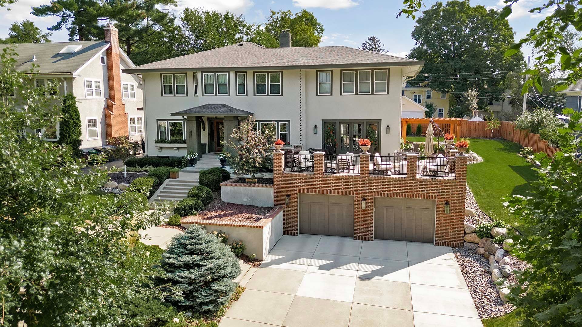 An aerial view of a large house with two garages