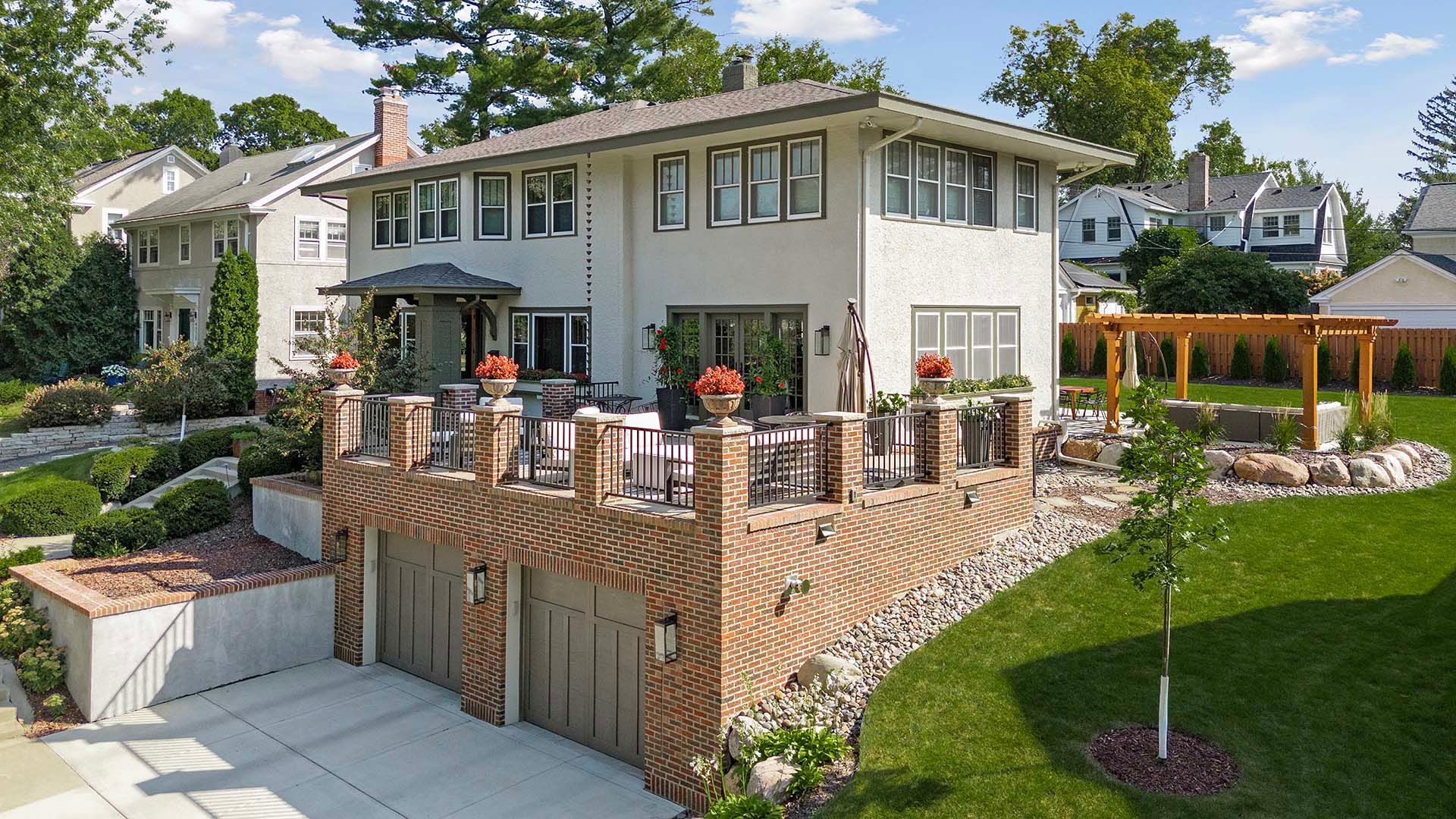 A large white house with a brick walkway leading to it