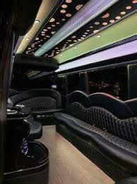 The inside of a limousine with a lot of seats and tables.