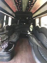 The inside of a limousine with a lot of seats and a couch.