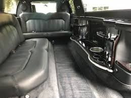 The inside of a limousine with a lot of seats and a table.