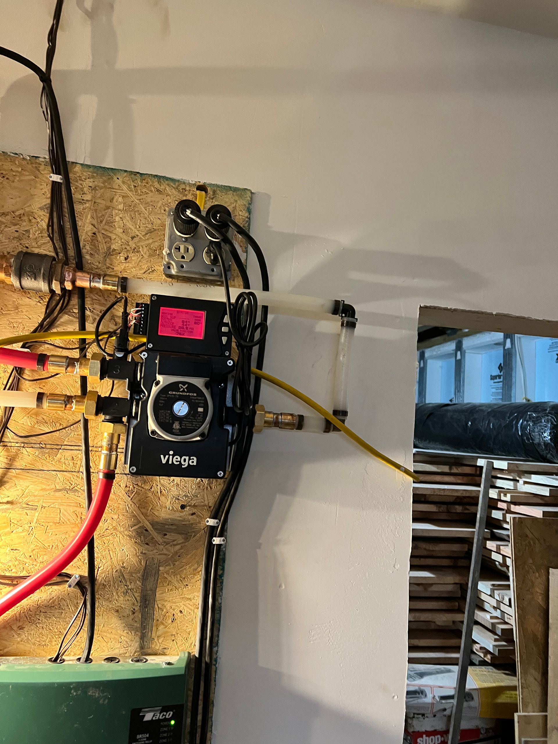 A wall with a bunch of wires hanging from it