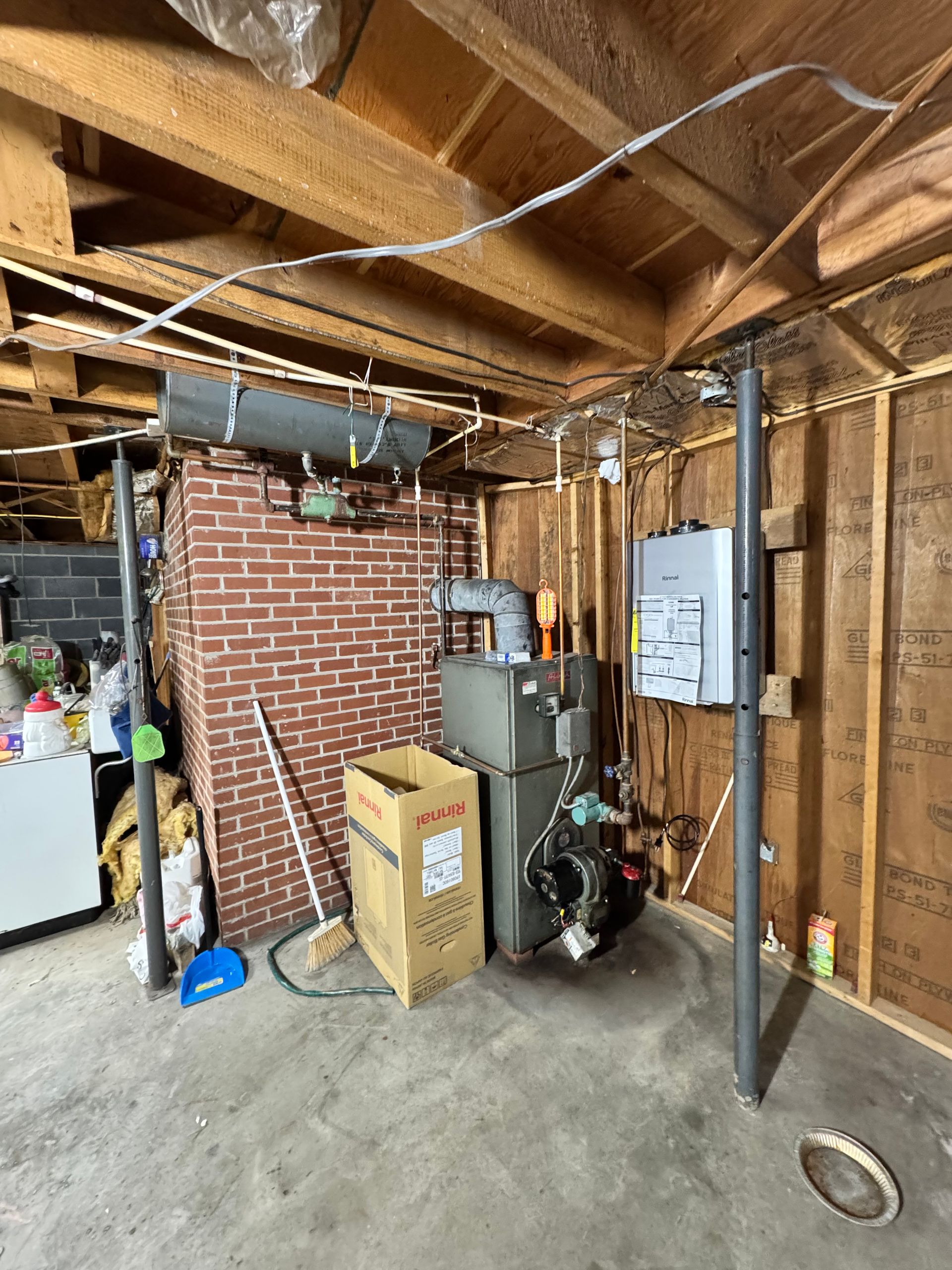 A basement with a stove and a box in it.