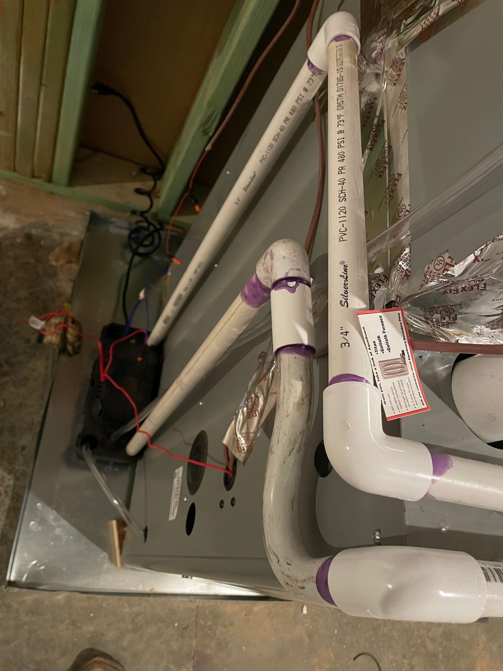 A bunch of pipes are connected to each other in a room.