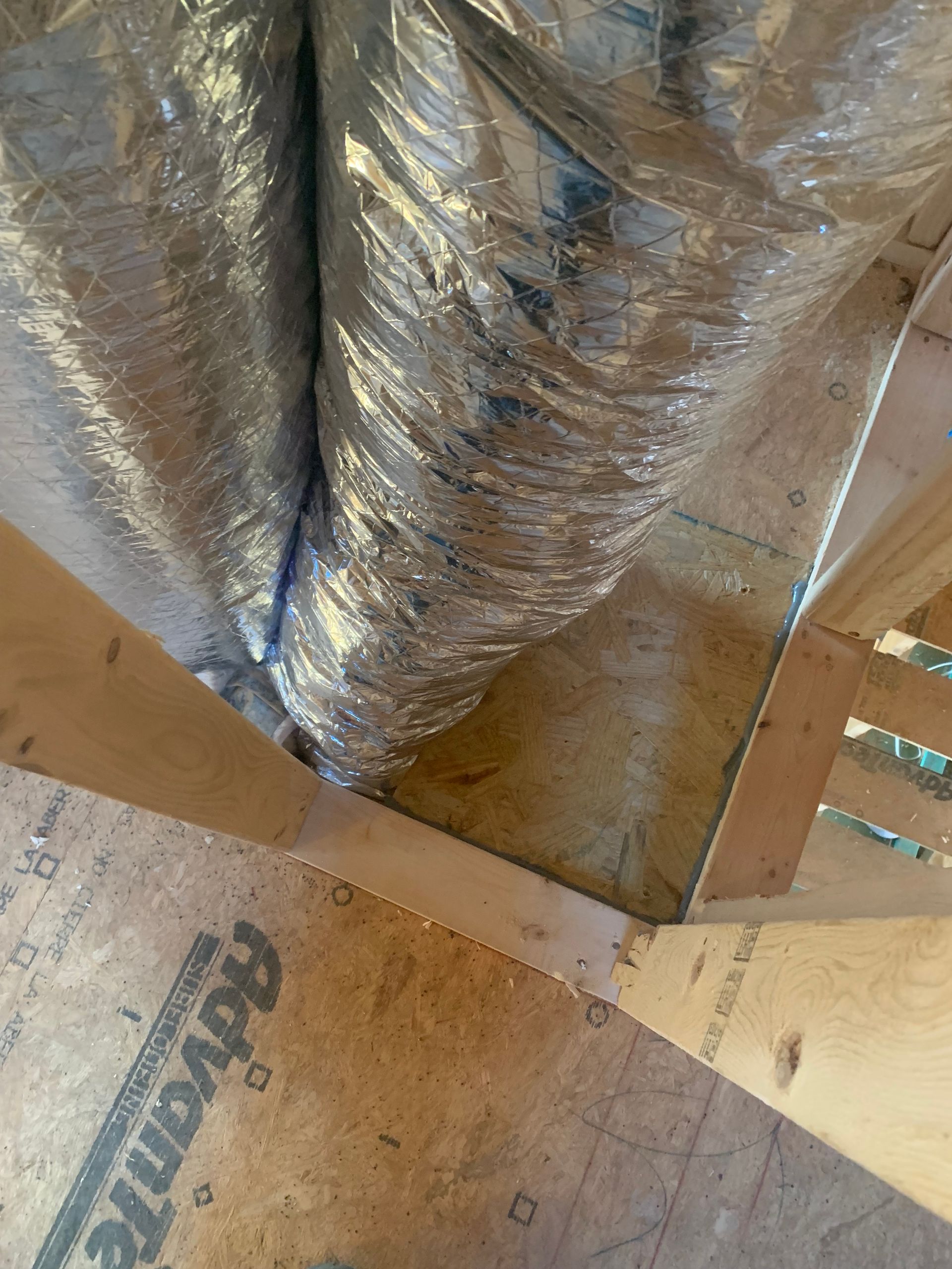 A bunch of ducts are sitting on top of a wooden floor.