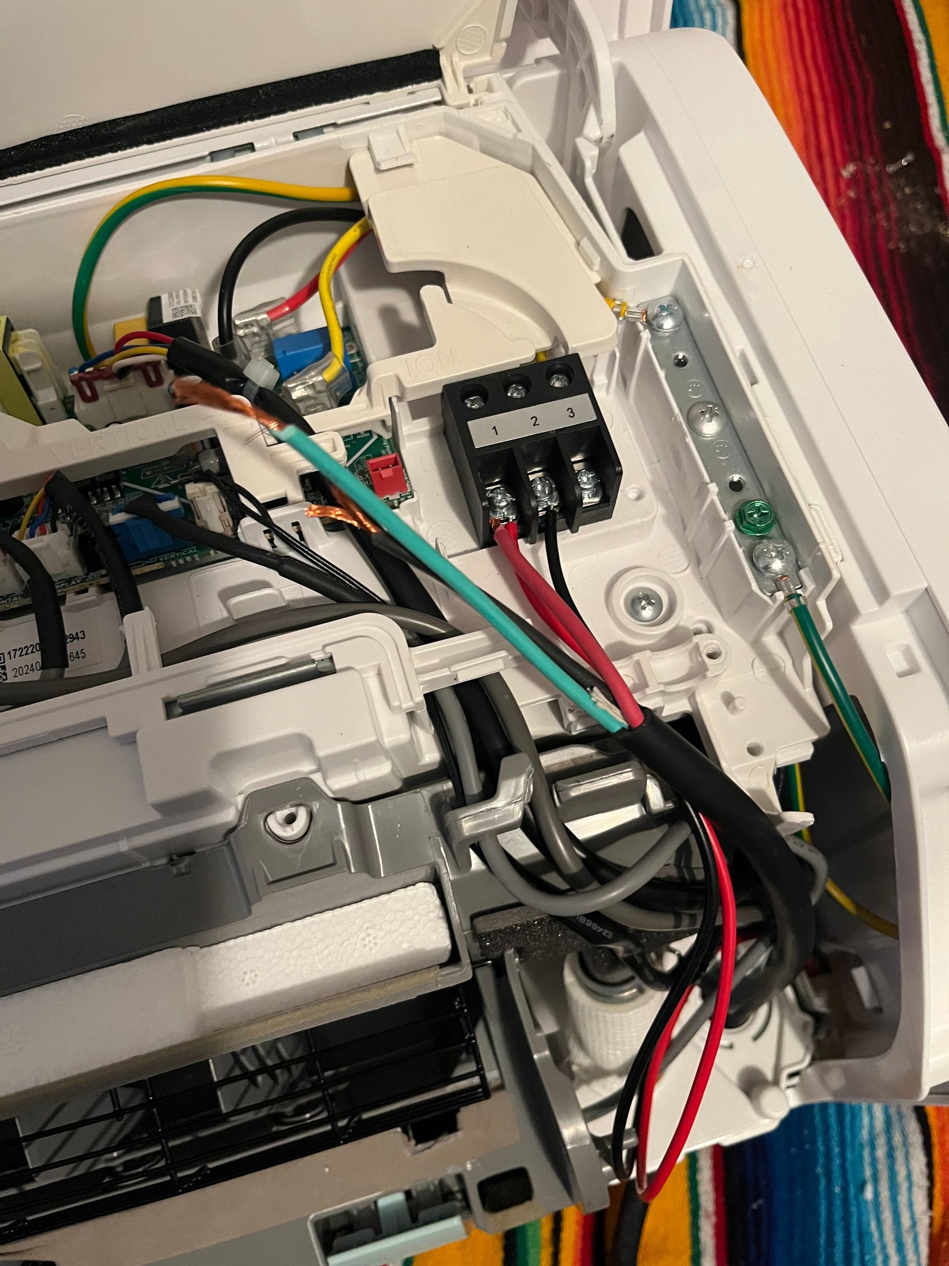 A close up of a computer with a bunch of wires coming out of it