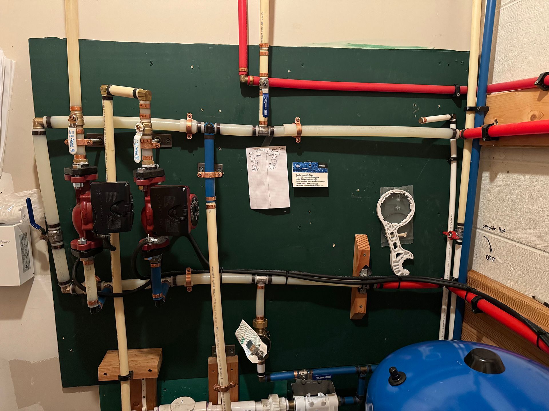 A room with a lot of pipes and a water tank