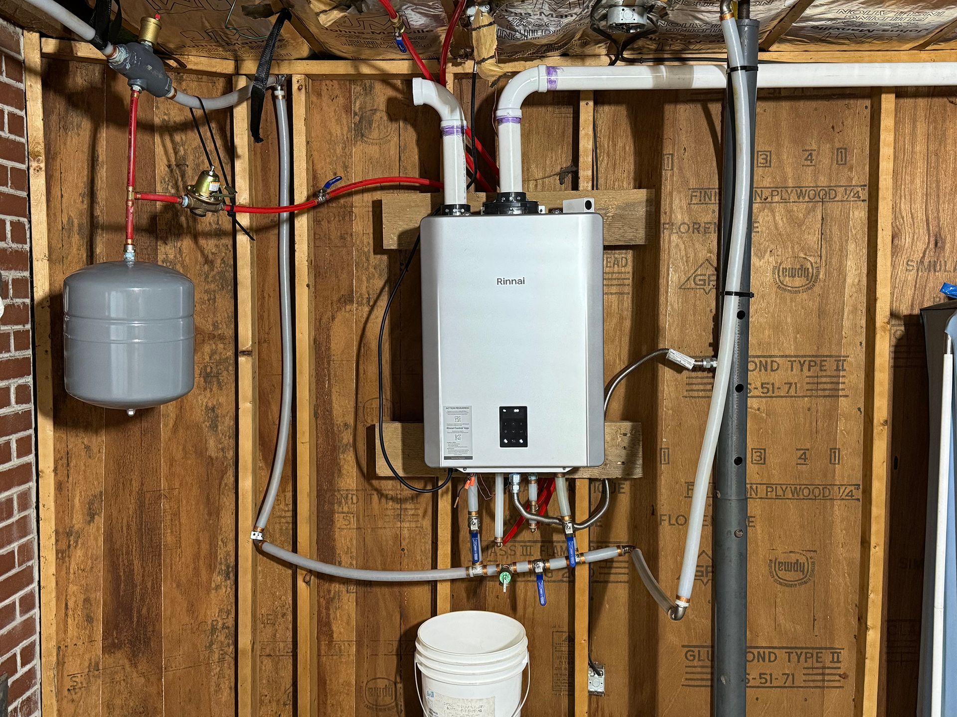 A boiler is hanging on a wall.