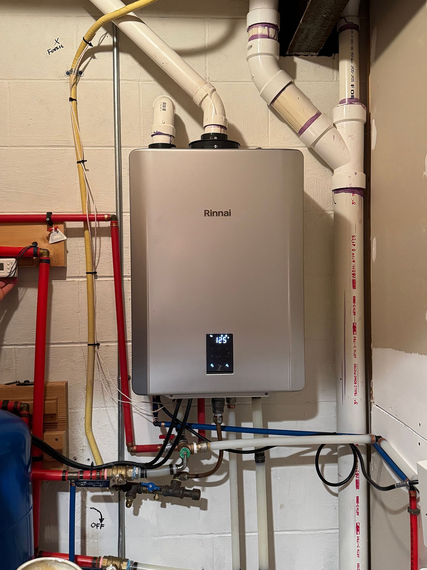 A boiler is hanging on a wall.