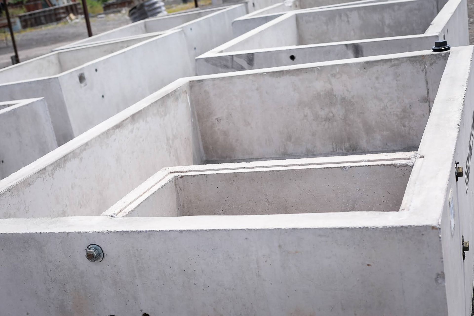 Concrete foundation walls forming rectangular compartments at a construction site