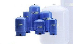A cluster of blue cylindrical water well pressure tanks of various sizes against a white background.