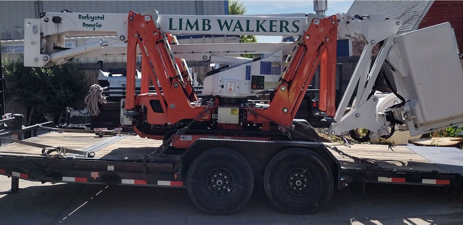 A trailer with a crane on it that says limb walkers