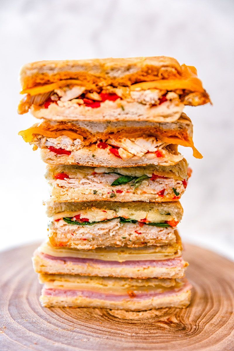 Paninis stacked on top of each other on a wooden board