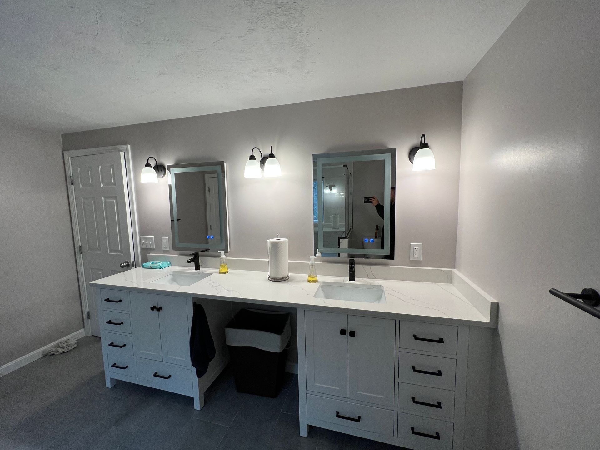 a bathroom with two sinks and two mirrors.