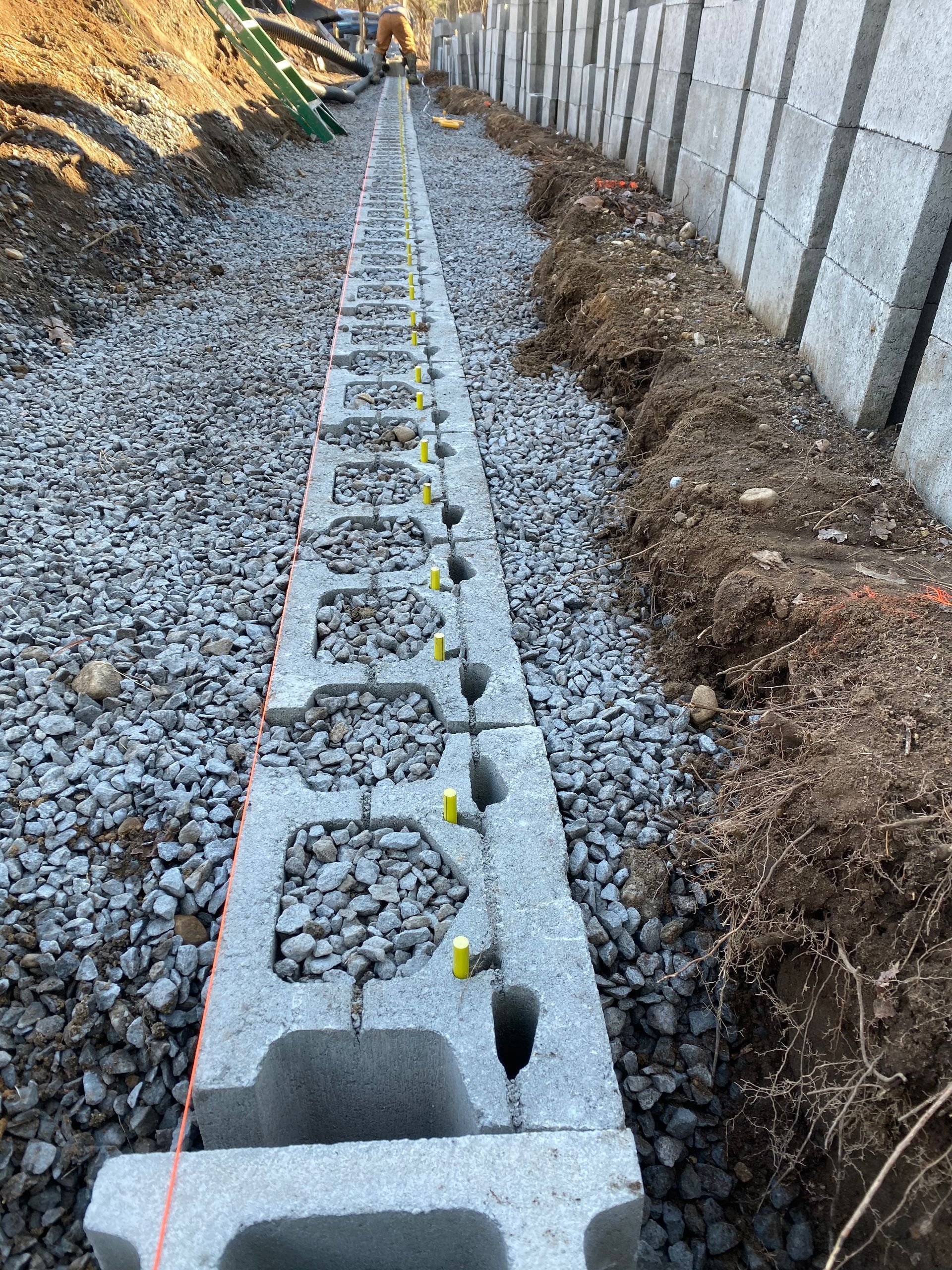 a row of concrete blocks sitting on top of a pile of gravel.