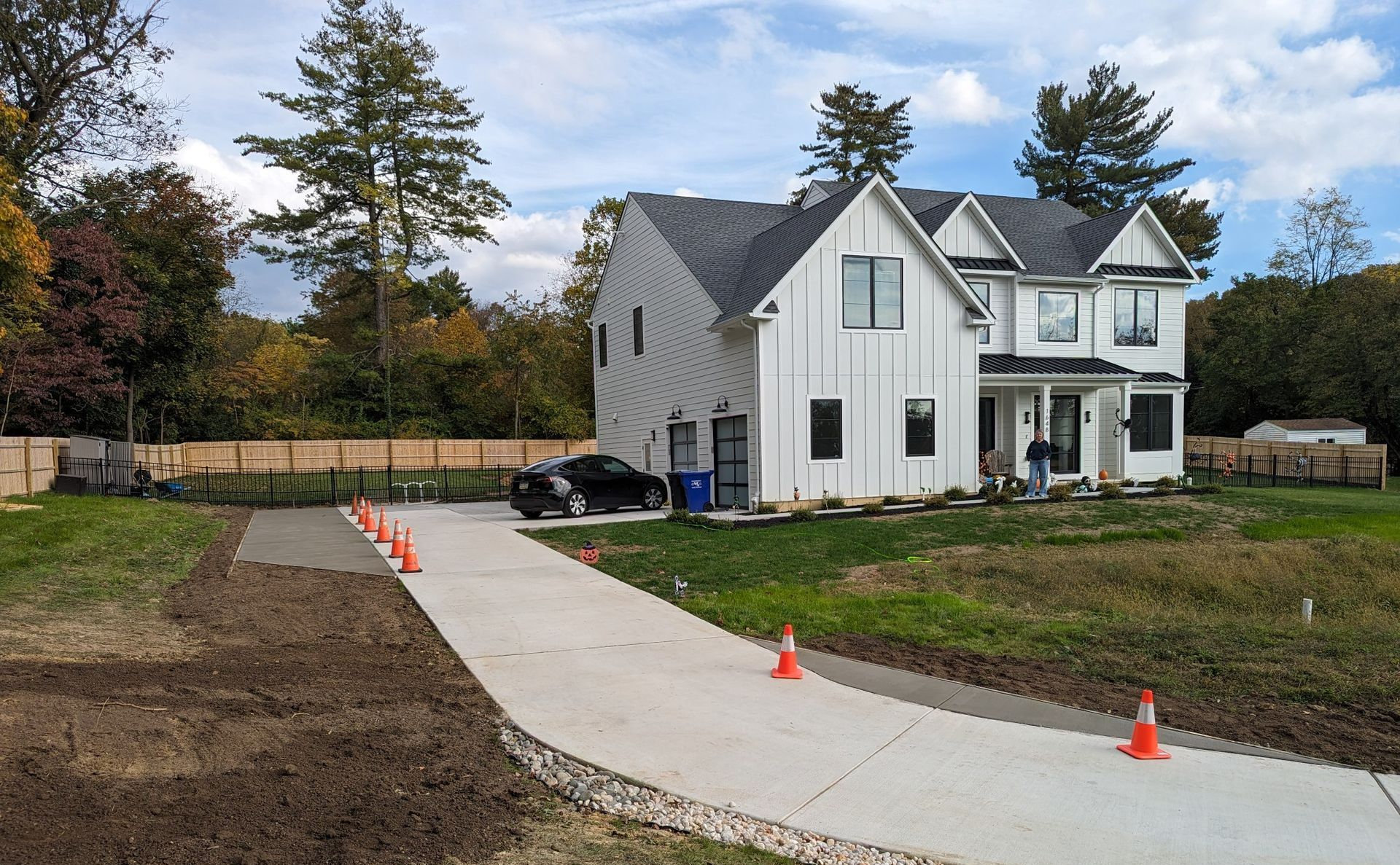 A concrete driveway is being built in front of a house