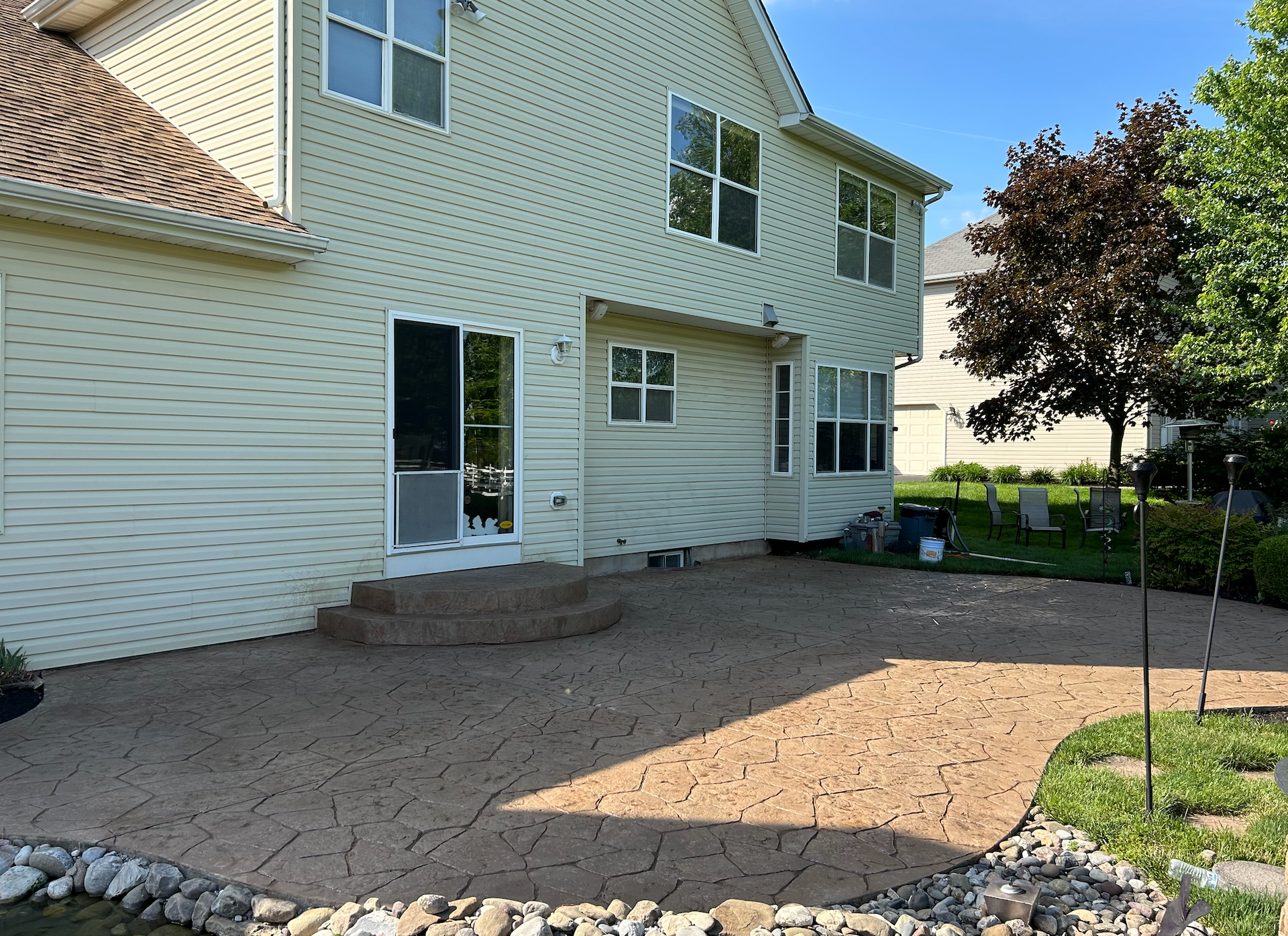 A large white house with a patio in front of it