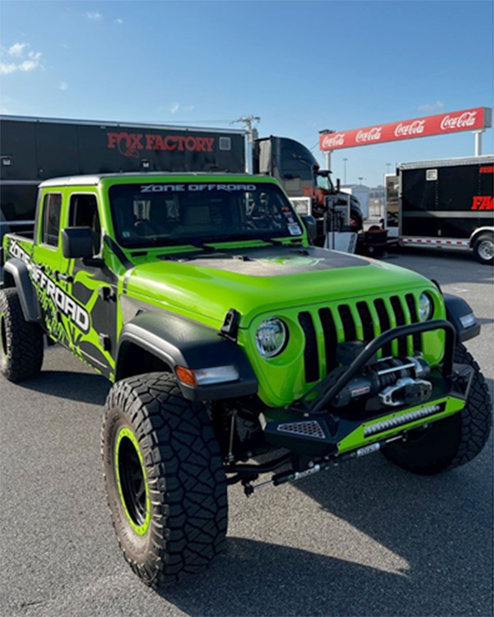 A green truck with lift kits