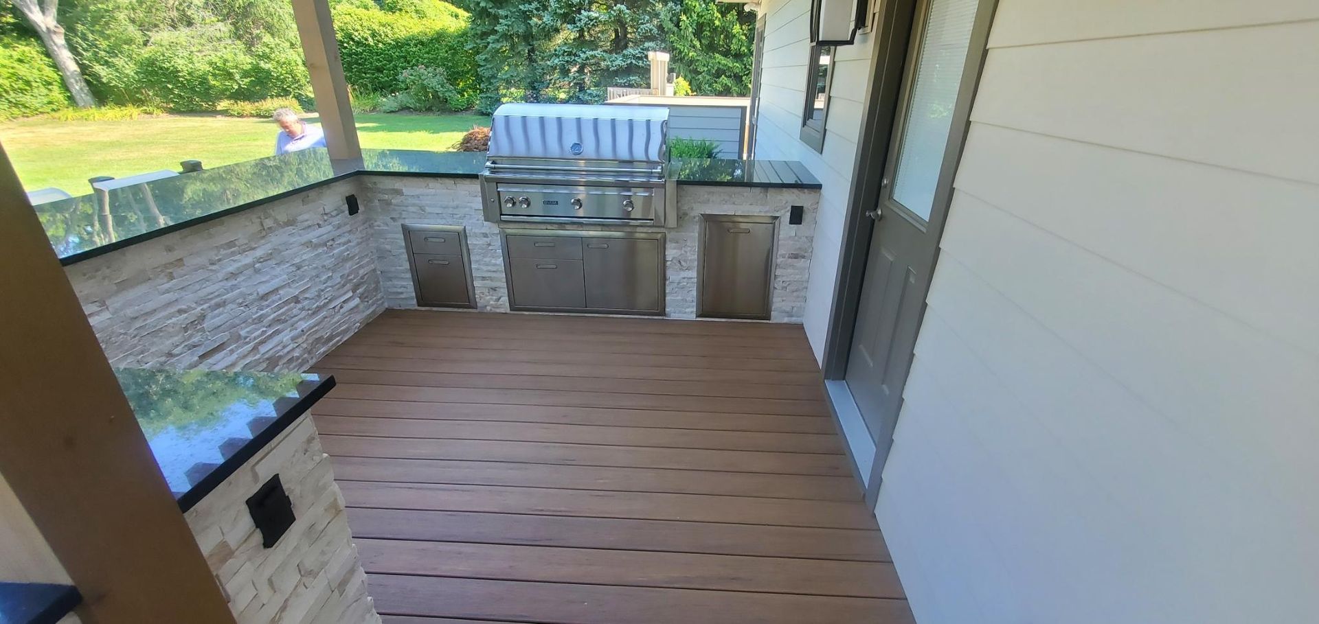 There is a grill on the porch of a house.
